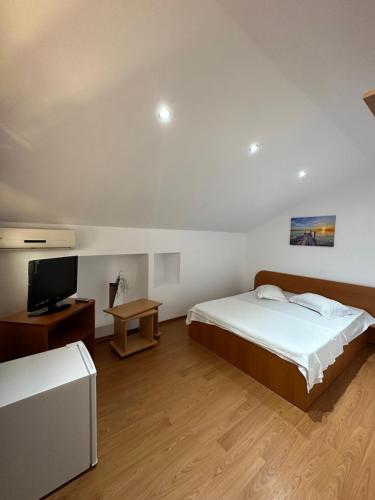 a hotel room with two beds and a television at Casa Anda in Mangalia