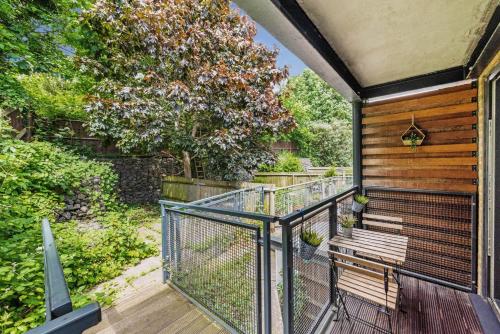 a balcony with a bench on a wooden deck at Manor House Studios By Morethanstays in London