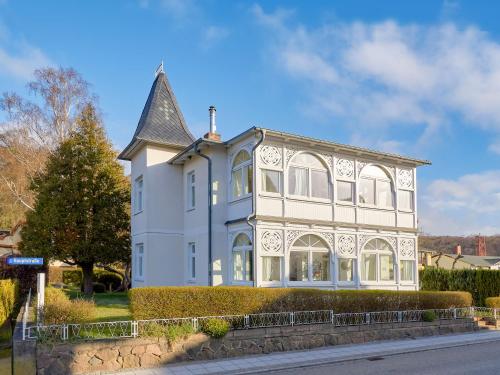 a large blue and white house on a street at Villa Sanssouci - Apt. 02 in Ostseebad Sellin