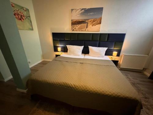 a bedroom with a large bed with two pillows at F-F Haus Monteuren Unterkunft in Neuhausen auf den Fildern