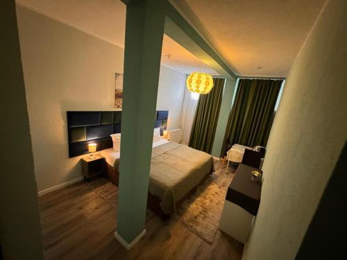 a bedroom with a bed and a chandelier at F-F Haus Monteuren Unterkunft in Neuhausen auf den Fildern