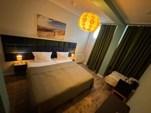 a bedroom with a large bed and a chandelier at F-F Haus Monteuren Unterkunft in Neuhausen auf den Fildern