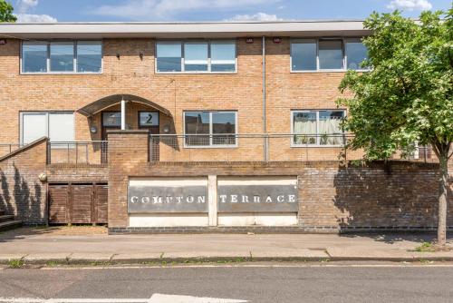 a brick building with a cotton exchange sign on it at Manor House Studios By Morethanstays in London