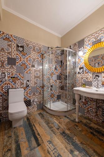 a bathroom with a toilet and a shower and a sink at Avra in Parga
