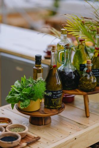 a table with several bottles and a plant on it at Saccharum - Resort and Spa - Savoy Signature in Calheta