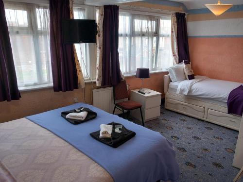 a hotel room with two beds with towels on them at My Adam Hotel in Blackpool