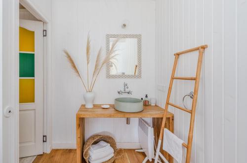 a bathroom with a sink and a mirror on a table at Coastal Cabin Engure in Engure