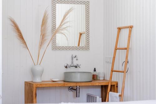 a bathroom with a sink and a mirror at Coastal Cabin Engure in Engure
