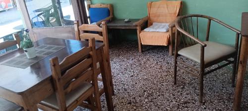a room with two chairs and a desk and a chair at Hotel zakros rooms-restaurant in Zákros