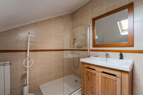 a bathroom with a sink and a shower and a mirror at Casa do Alambique - Douro in Armamar