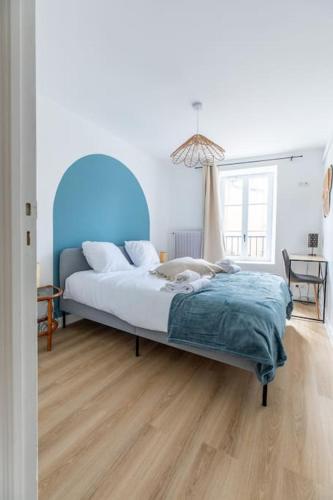 - une chambre avec un lit bleu et du parquet dans l'établissement Cosy Saint-Pierre centre-ville, à Clermont-Ferrand