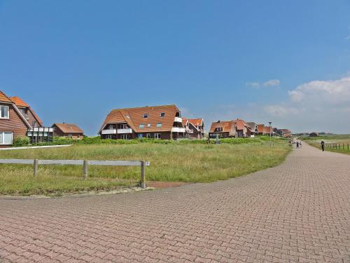 eine Ziegelsteinstraße mit Häusern im Hintergrund in der Unterkunft Studio mit Meerblick auf die Robbenbänke von Norderney, geschützter Südwestbalkon in Baltrum