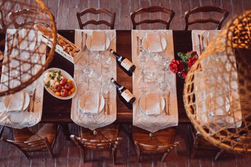 a table with bottles of wine and a plate of food at Scarpa Villas - Barolo Luxury Escape in Verduno