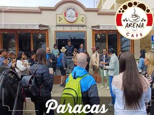 a crowd of people standing outside of a cafe at Arena Hostal in Paracas