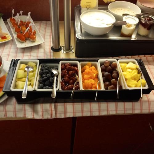 a tray filled with different types of food on a table at Stadt-gut-Hotel Rheinischer Hof in Essen