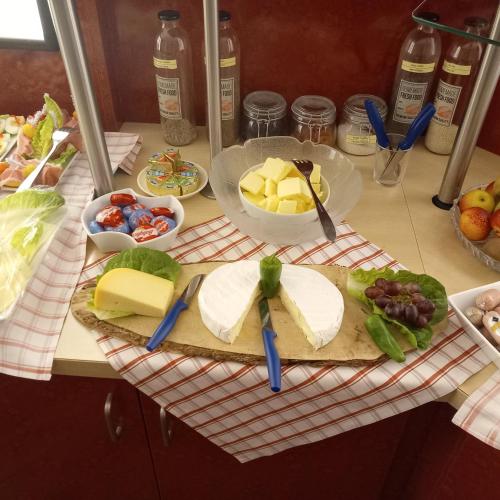 a table with cheese and other foods on it at Stadt-gut-Hotel Rheinischer Hof in Essen