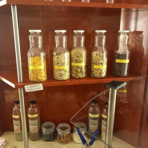 a group of bottles of seasoning on a shelf at Stadt-gut-Hotel Rheinischer Hof in Essen