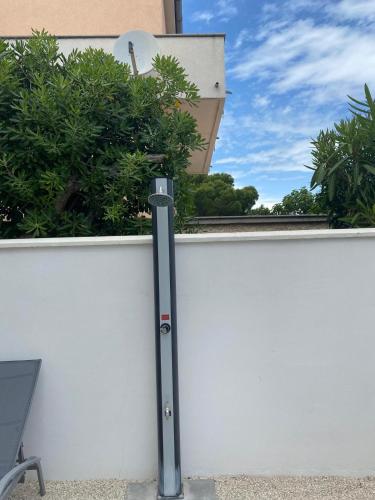 a metal pole on the side of a white wall at Seaview Kamenjak in Premantura