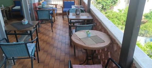 a row of tables and chairs on a patio at Hotel zakros rooms-restaurant in Zákros