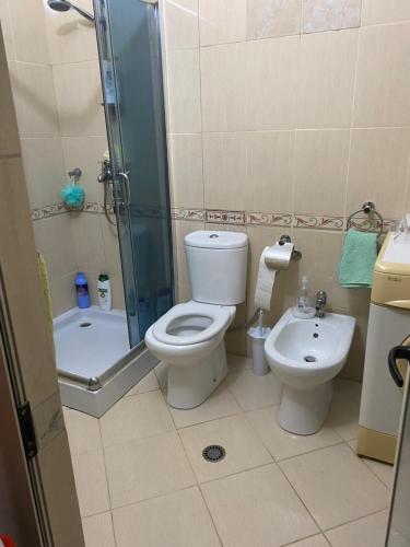 a bathroom with a toilet and a shower and a sink at Isabel in Durrës