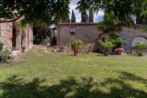 a house with a yard with chairs and plants at La Casa di Colle in Dicomano