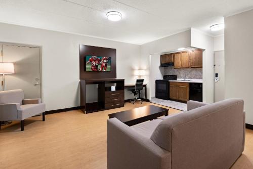 a living room with a couch and a table at Red Roof Inn Norwich in Norwich