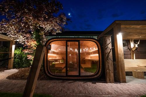 a house with a round window on a brick sidewalk at Van der Valk Hotel Gilze-Tilburg in Tilburg
