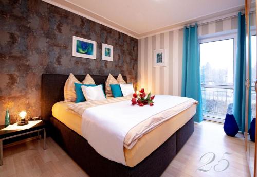 a bedroom with a large bed and a window at Komfortables Appartement In Bad Kötzting Mit Eintritt In Die Bade Und Saunawelt in Bad Koetzting