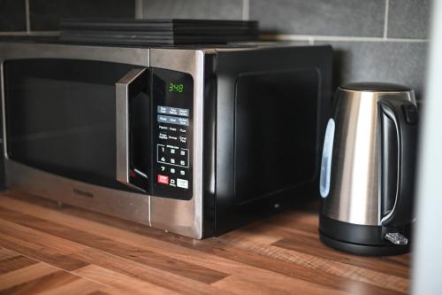 a microwave oven sitting on top of a wooden floor at 2 Bedroom Flat, Fabulous Views near Beamish Museum in Beamish