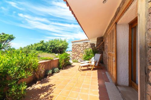 a patio with a table and chairs on a house at Villa Gabbiani in Vignola Mare