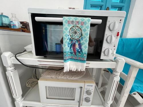 a microwave oven with a towel on top of it at Oia Sunset House Pothitou in Oia