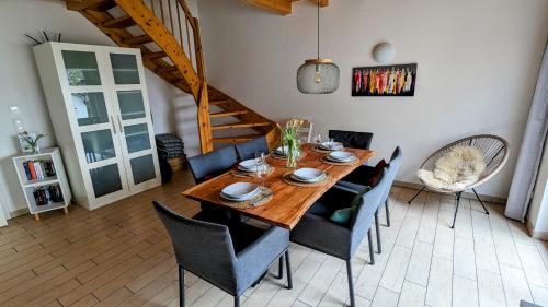 a dining room with a wooden table and chairs at Haus Linda in Plau am See