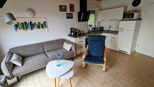 a living room with a couch and a table and a kitchen at Haus Linda in Plau am See