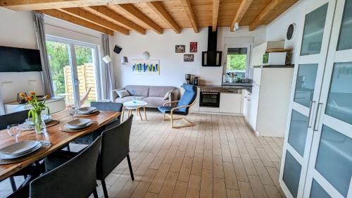 a dining room and living room with a table and chairs at Haus Linda in Plau am See