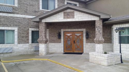 a brick house with a wooden door in front at Premium Inn and Suites in Killeen