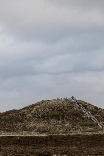a hill with people standing on top of it at Strönhof Kampen in Kampen