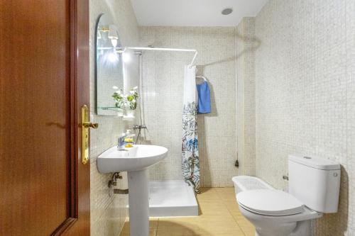 a bathroom with a toilet and a sink at Somar in Puerto de las Lajas