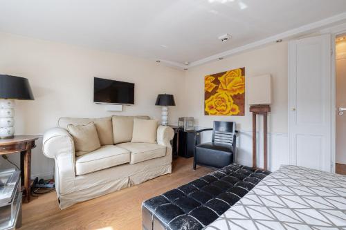 a living room with a couch and a tv at Strönhof Kampen in Kampen