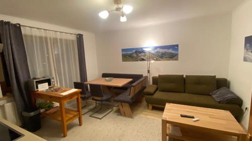een woonkamer met een bank en een tafel bij Appartement Schareckblick in Bad Gastein