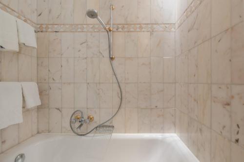a shower in a bathroom with a tub at Strönhof Kampen in Kampen