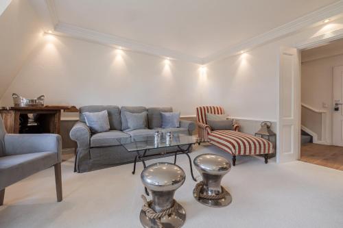 a living room with a couch and a table at Strönhof Kampen in Kampen