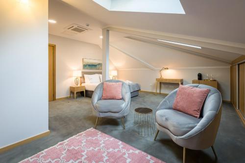 a living room with two chairs and a bed at Comtesse Lisbonne Guest House by Homing in Lisbon