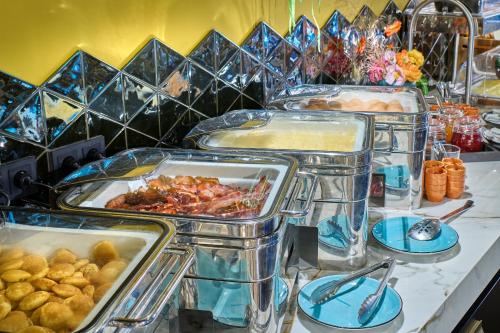 a buffet with several trays of food on a table at Hotel Restaurant Grandcafé 't Voorhuys in Emmeloord