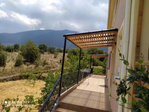 a balcony of a house with a view at Villa in idyllic quiet nature in Benettáta