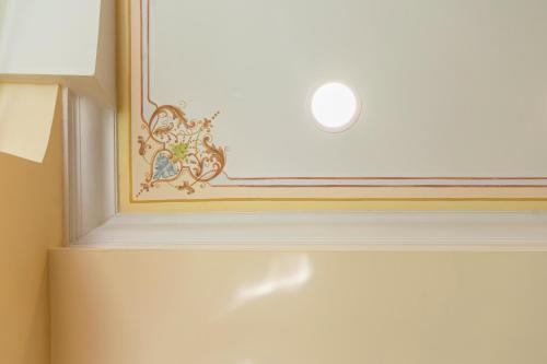 a ceiling with a window with a painting on it at Boutique Hotel Heritage in Fiuggi