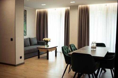 a living room with a table and a couch at Rest&Ski Spa Resort in Bukovel
