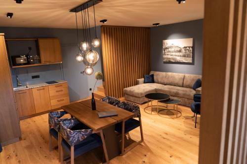 a living room with a table and a couch at Weindomizil Hagn in Mailberg
