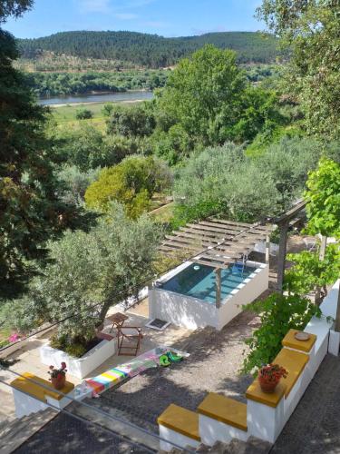 a villa with a swimming pool in a garden at Casa da Praia do Ribatejo in Praia do Ribatejo