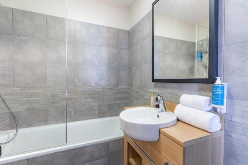 漢斯的住宿－Appart'City Classic Reims Parc des Expositions，浴室配有盥洗盆和浴缸。