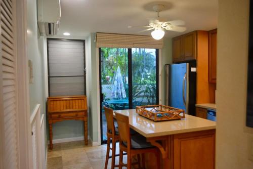 a kitchen with a table and a refrigerator at Ocean Pearl in Kahuku
